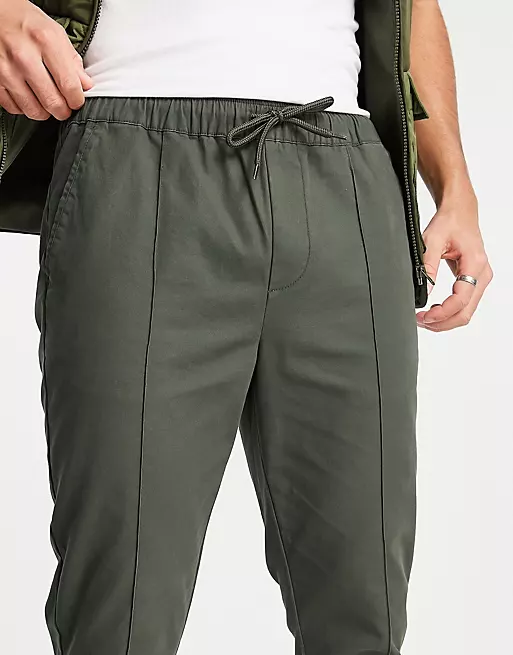ASOS DESIGN - Pantalon chino skinny à plis nervurés et taille élastique - Vert foncé